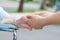 Caregiver holding elderly womans hand