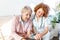 Caregiver measuring blood pressure of senior woman at home. Kind carer measuring the blood pressure of a happy elderly woman in