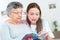 Caregiver reading book with elderly patient