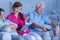 Caregiver reading book to patients