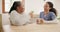 Caregiver, retirement and women with coffee talking, in conversation and relax in nursing home. Healthcare, wellness and