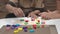 Caregiver and senior woman playing wooden shape puzzles game for dementia prevention