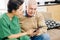 Caregiver showing mobile app to patient