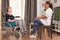 Caregiver talking with a disabled woman