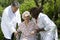 Caregivers assisting a senior patient in wheelchair