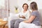 Carer having a cup of tea with an elderly woman