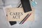 CARES ACT wooden sign office business supplies pencils calculators flat lay background