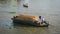 Cargo boat carrying rice on river in Ben Tre, Vietnam