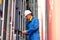 Cargo container with blue collar and safety protection uniform use barcode scaner to check product and stay between stack of the