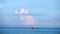 Cargo container ship sailing in still frozen summer sea on blue cloudy sky background. Shot. Red barge floating in blue