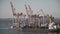 Cargo container terminal port in Odessa. Cargo port with working harbor cranes. Bulk cargo ship under port crane bridge