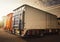 Cargo Container Trucks on Parking Lot at Distribution Warehouse. Freight Truck Logistics Cargo Transport