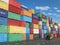 Cargo containers in shipping yard and forklift. Delivery shipping logistic import export industrial concept.