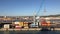 Cargo containers transport and crane at Italian sea port industrial district of Livorno, Italy.