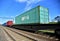 Cargo Containers Transportation On Freight Train By Railway. Intermodal Container On Train Car. Rail Freight Shipping Logistics.