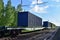 Cargo Containers Transportation On Freight Train By Railway. Intermodal Container On Train Car. Rail Freight Shipping Logistics