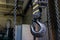 Cargo crane hook of a manual chain winch in an old factory. Dark background.