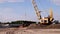 Cargo crane operation. Large cargo crane unloads sand. Sand mining
