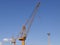 Cargo cranes in the port of Bremerhaven with a blue sky.
