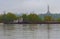 Cargo delivery by river transport. The tug boat towing a barge with sand. The Motherland monument in the background