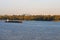 Cargo delivery by river transport. The tug boat towing an empty barge. Scenic morning autumn landscape of Kyiv. Nature landscape.