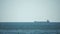 Cargo and dredging industrial ships sailing in to sea horizon. One large cargo ship grain carrier tanker in sea on sunny