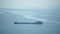 Cargo and dredging industrial ships sailing in to sea horizon. One large cargo ship grain carrier tanker in sea on sunny