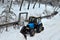 Cargo dump truck rides on a snowy road to load sand