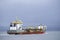 Cargo export container carrier ship vessel on sea under dark sky