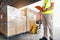 Cargo freight truck. Warehouse worker holding clipboard his control loading cargo pallet into shipping container.