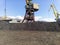 Cargo industrial port, port cranes. Loading of anthracite. Transportation of coal. Heap of coal