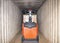 Cargo pallet shipment, Freight truck, Delivery service. Electric forklift pallet jack loading cargo pallet inside cargo container.