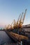 Cargo port with cranes for lifting containers at sunset