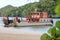 A cargo ship carrying material is docked at the beach. Island areas in Thailand