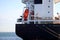 Cargo ship close up. Freight ship with orange lifeboat.