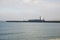 A cargo ship departing Aberdeen port between two lighthouses at Harbour entrance