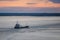 Cargo Ship on a Frozen River at Sunset