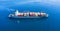 Cargo ship full loaded with containers, blue sea background