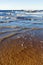 Cargo ship on the horizon in a strong tide with waves