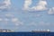 cargo ship nearby Capo Peloro Lighthouse in Punta del Faro on the Strait of Messina, most north eastern promontory of Sicily,