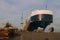 A cargo ship is parked in a shipyard