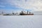 Cargo ship pushes tug in the ice