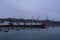 Cargo ship on the river, carrying out transportation against the background of trees and equipment working in the port