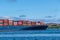 Cargo ship sailing with hundreds of colored containers