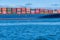 Cargo ship sailing with hundreds of colored containers