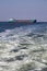 Cargo ship on the sea with waves foreground