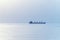 Cargo ship silhouette at horizon