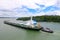 Cargo Ship and Tug Boat at Lake Gatun, Panama Canal, Panama. Central America Man made Lake