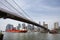 Cargo ship under brooklyn bridge, New York City
