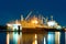 Cargo ship under repair in floating dry dock at night